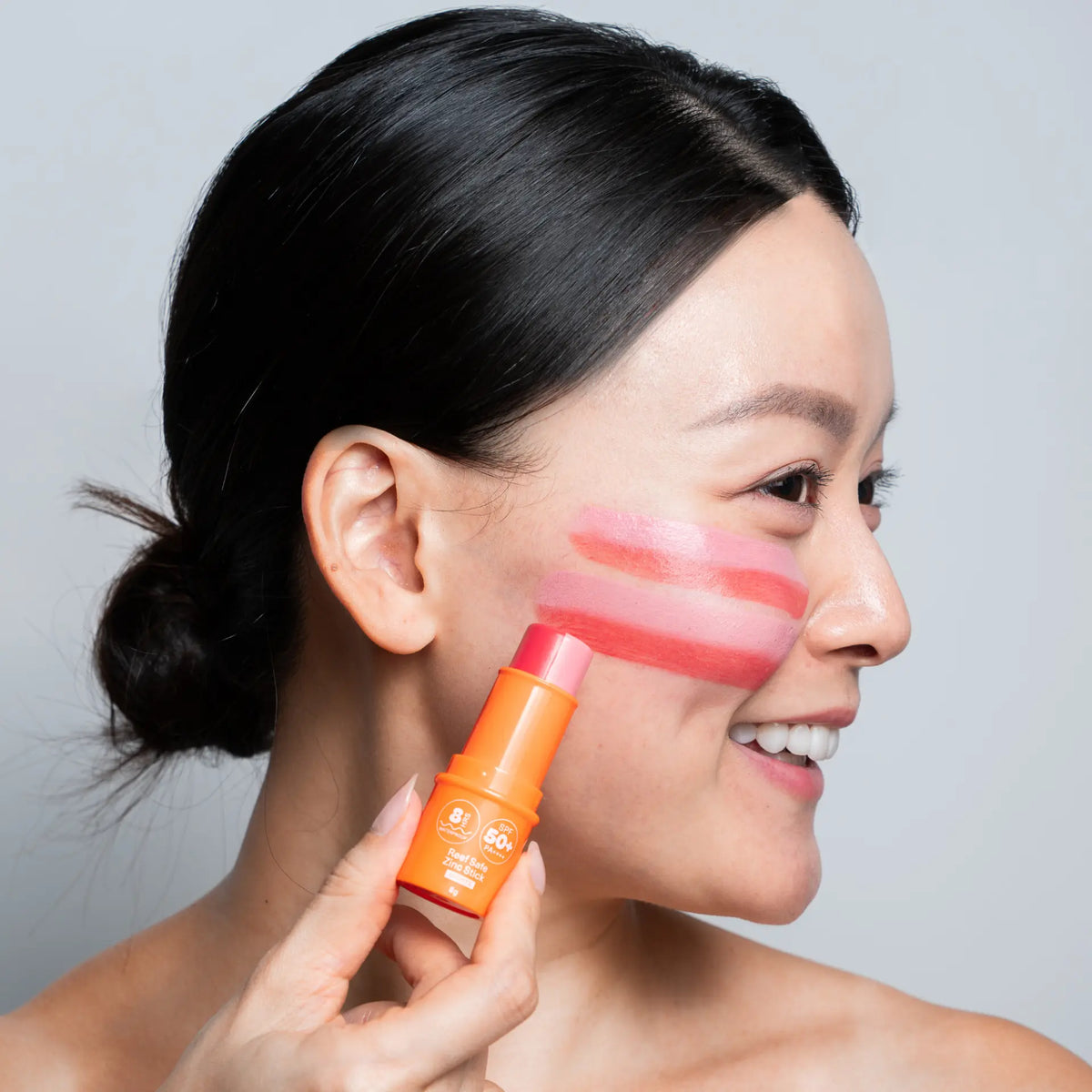 Model wearing Sunbeam zinc stick in Rose
