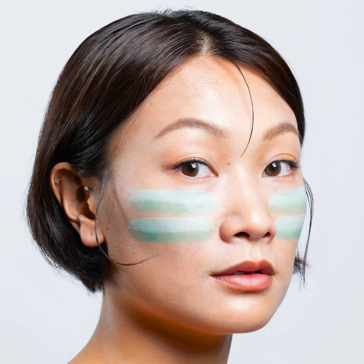 Model wearing Sunbeam zinc stick in Jade
